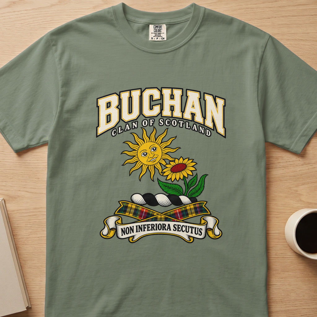 Buchan clan crest with sun and flower on a sage green Comfort Colors T-shirt, front view