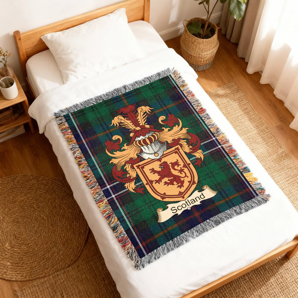 Tartan blanket with Scottish coat of arms featuring a lion and banner.