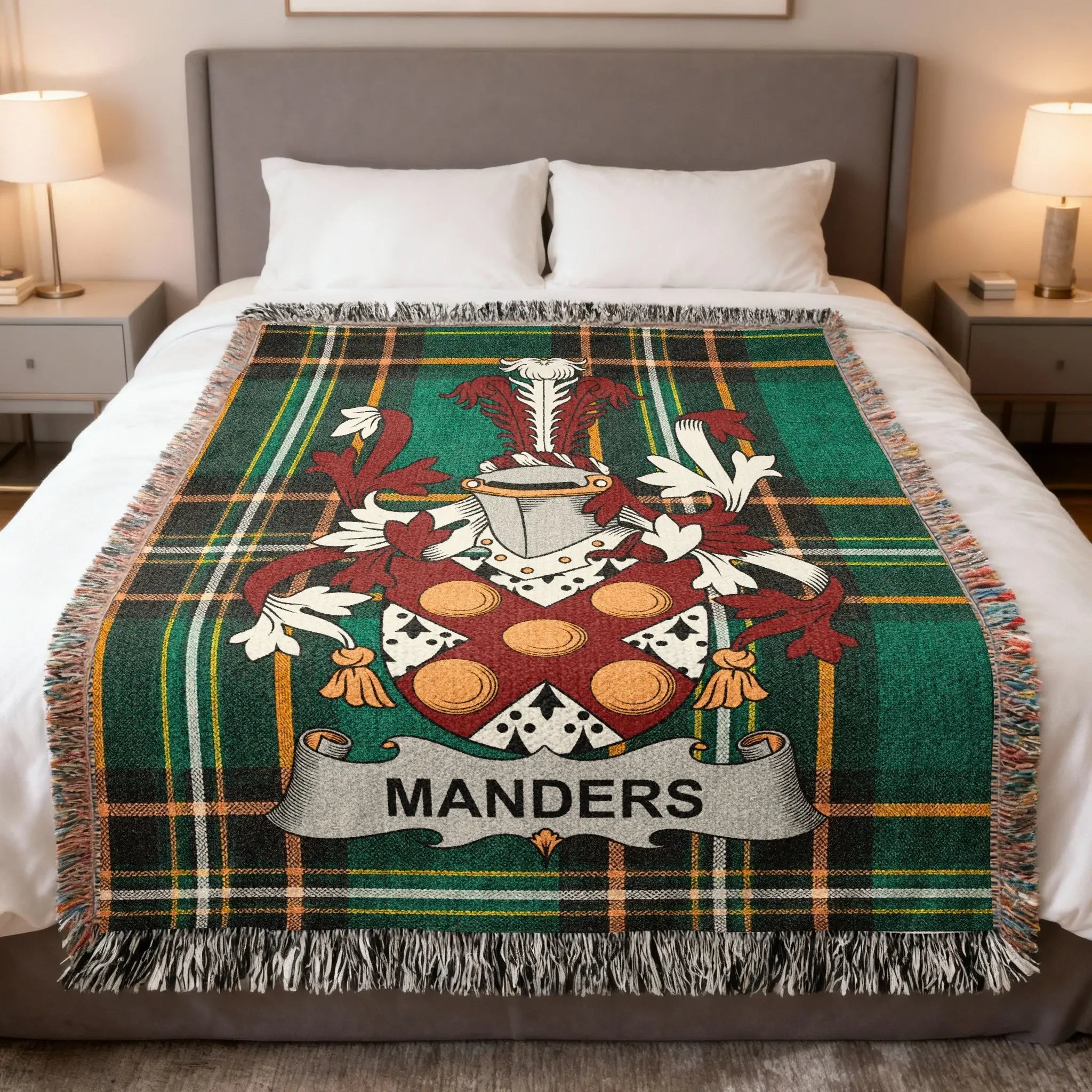 Woven tartan blanket with MANDER'S family crest on a bed.