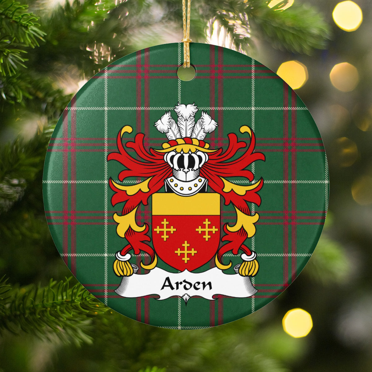 Arden ornament among Christmas tree branches and warm lights; three small gold crosses on red beneath a plain gold top band on Welsh national tartan.