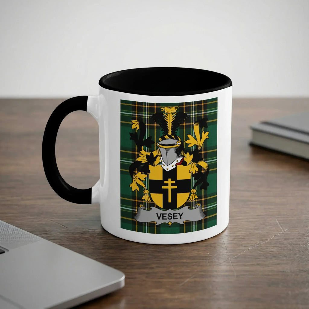 White mug with black handle, featuring the Vesey family crest on a plaid background.