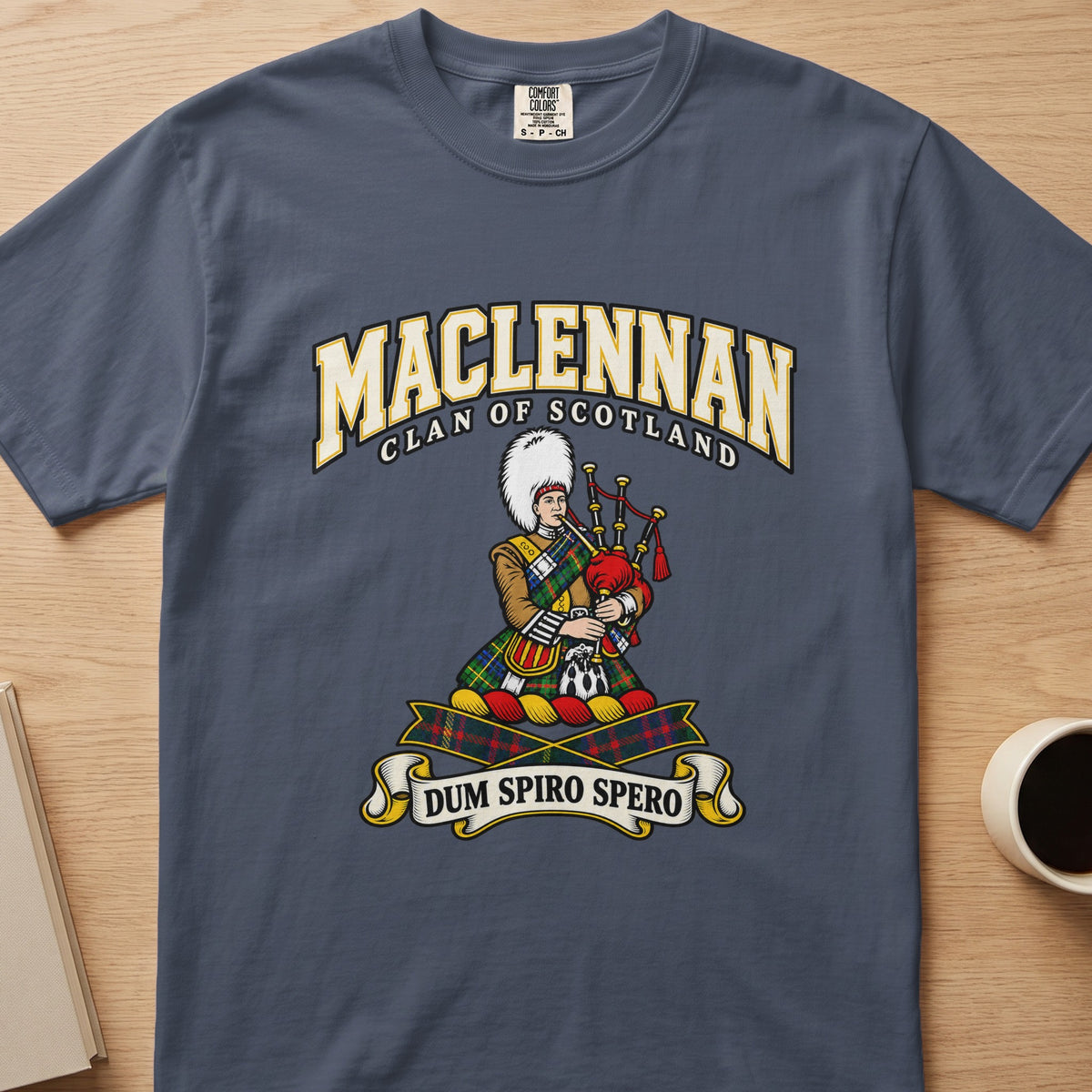 MacLennan clan crest with tartan-clad piper on a slate blue Comfort Colors T-shirt, front view