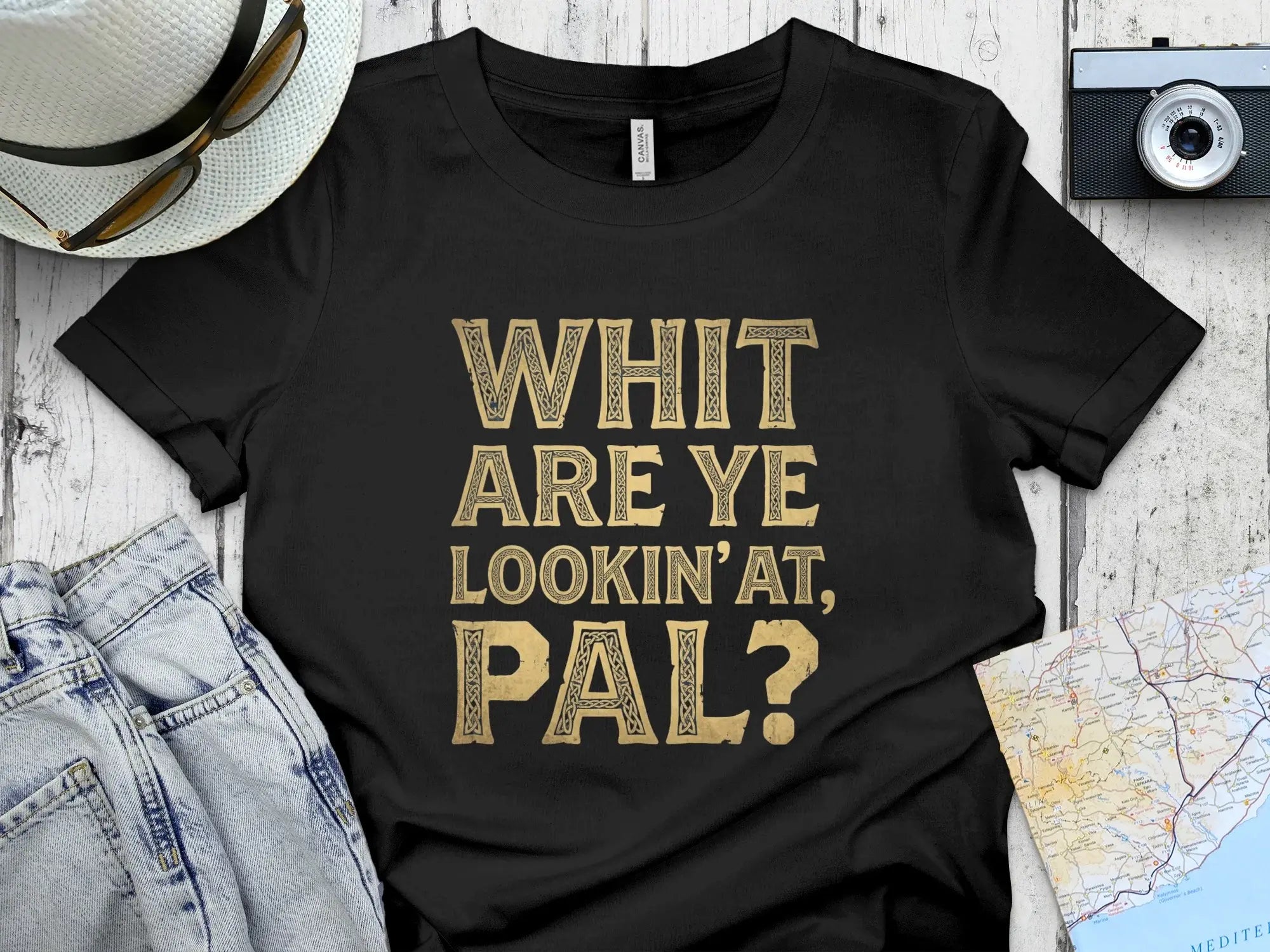 Black t-shirt with "WHIT ARE YE LOOKIN'AT, PAL?" in distressed gold text.
