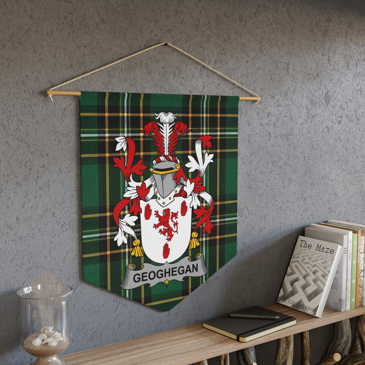 Geoghegan family crest on green tartan pennant hanging on wall.