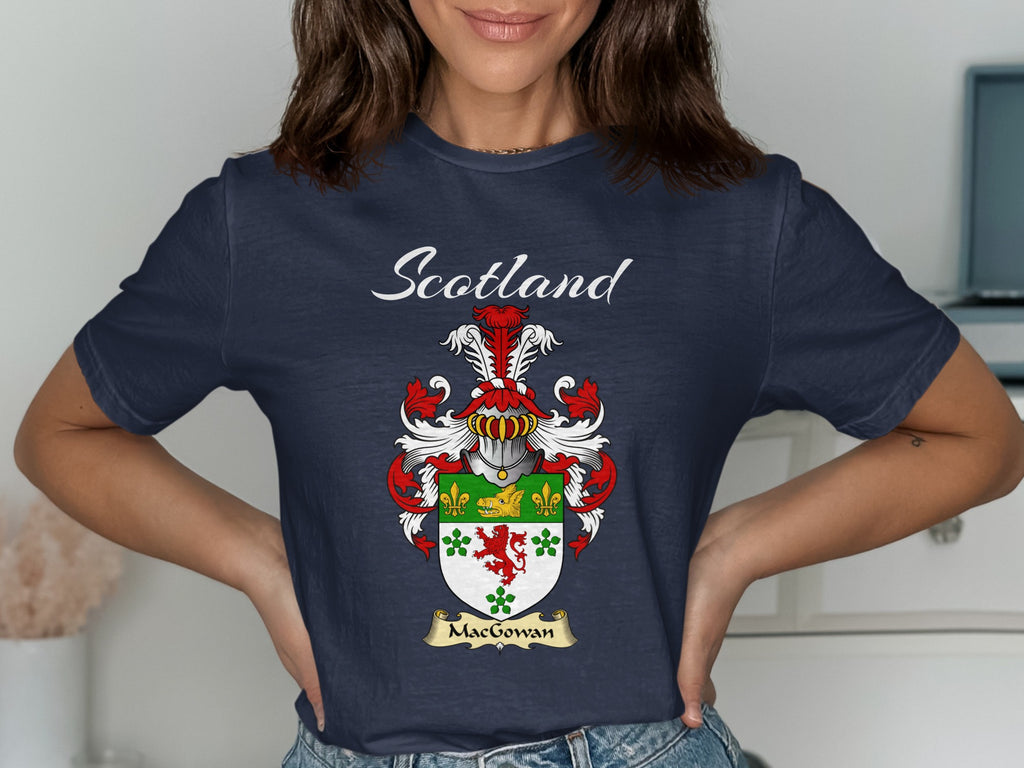 Model wearing a navy MacGowan T-shirt featuring a green-and-white shield with a red lion and clover motifs