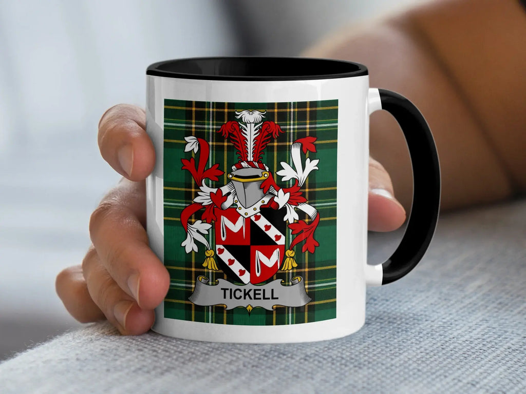 White mug with black rim featuring the Tickell family crest on plaid background.