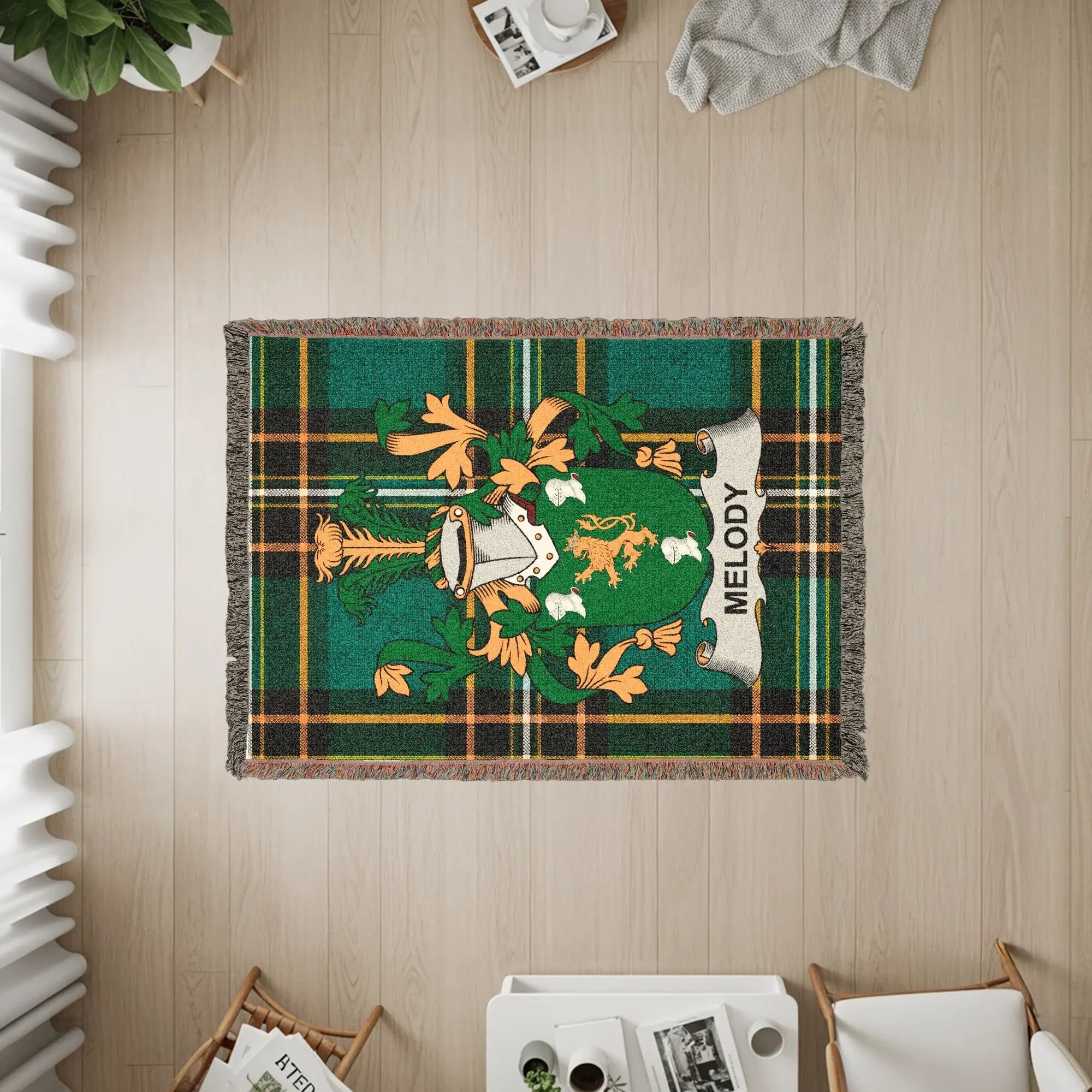 Woven blanket featuring the Melody family crest on a green and yellow plaid background.