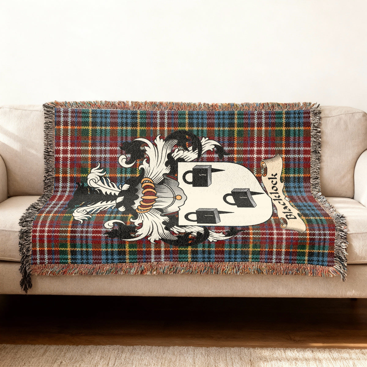 Blacklock Scottish woven blanket with family shield and Caledonia tartan background