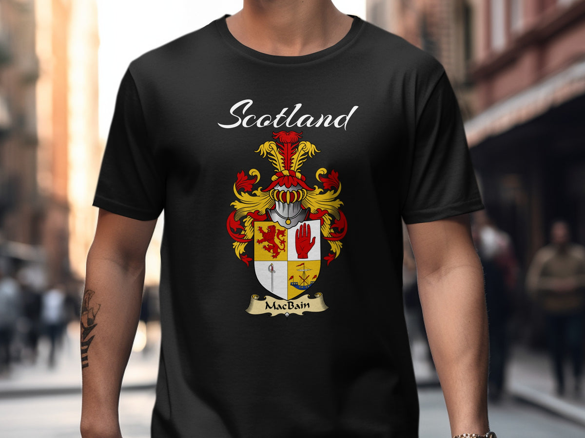 Model wearing a black MacBain T-shirt featuring a quartered shield featuring a red lion and an upright hand