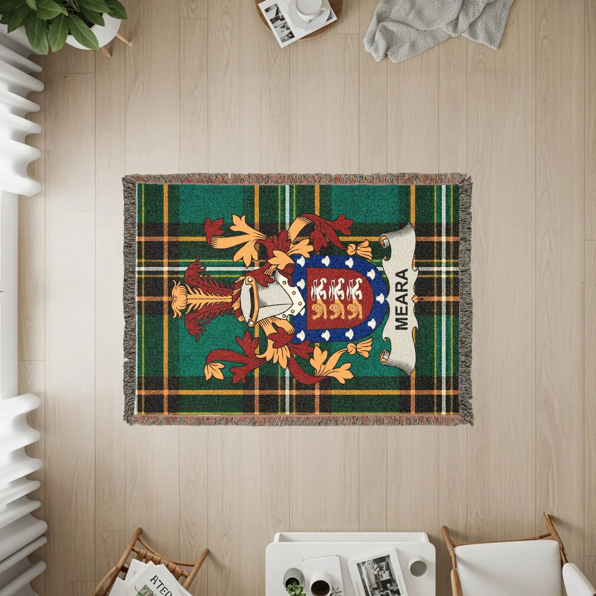 Woven blanket with Meara family crest and plaid pattern.
