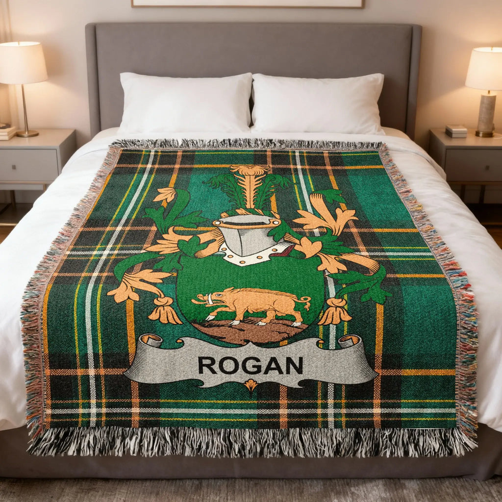 Tartan blanket with Rogan family crest featuring a boar and green, gold, and black plaid.