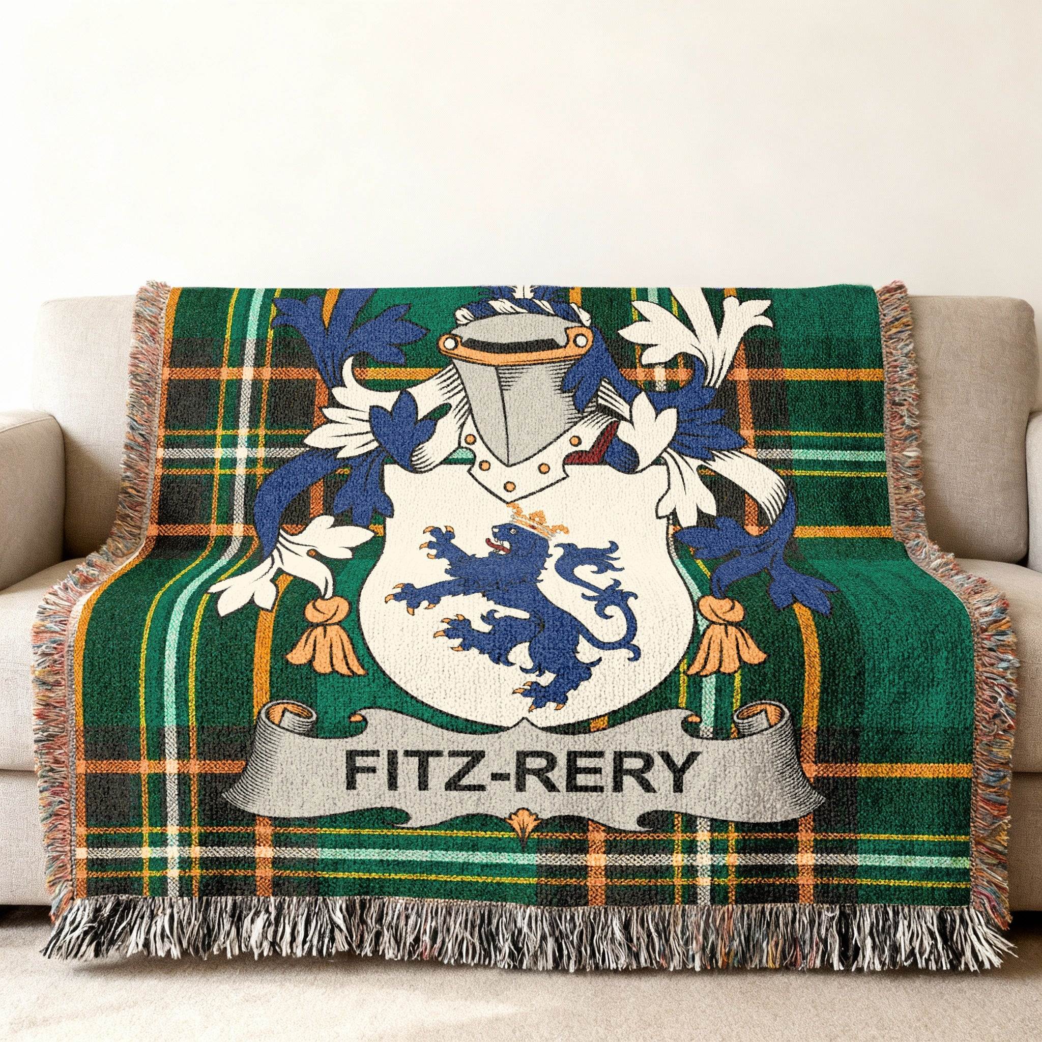 Plaid throw blanket with FITZ-RERY family crest on a sofa.