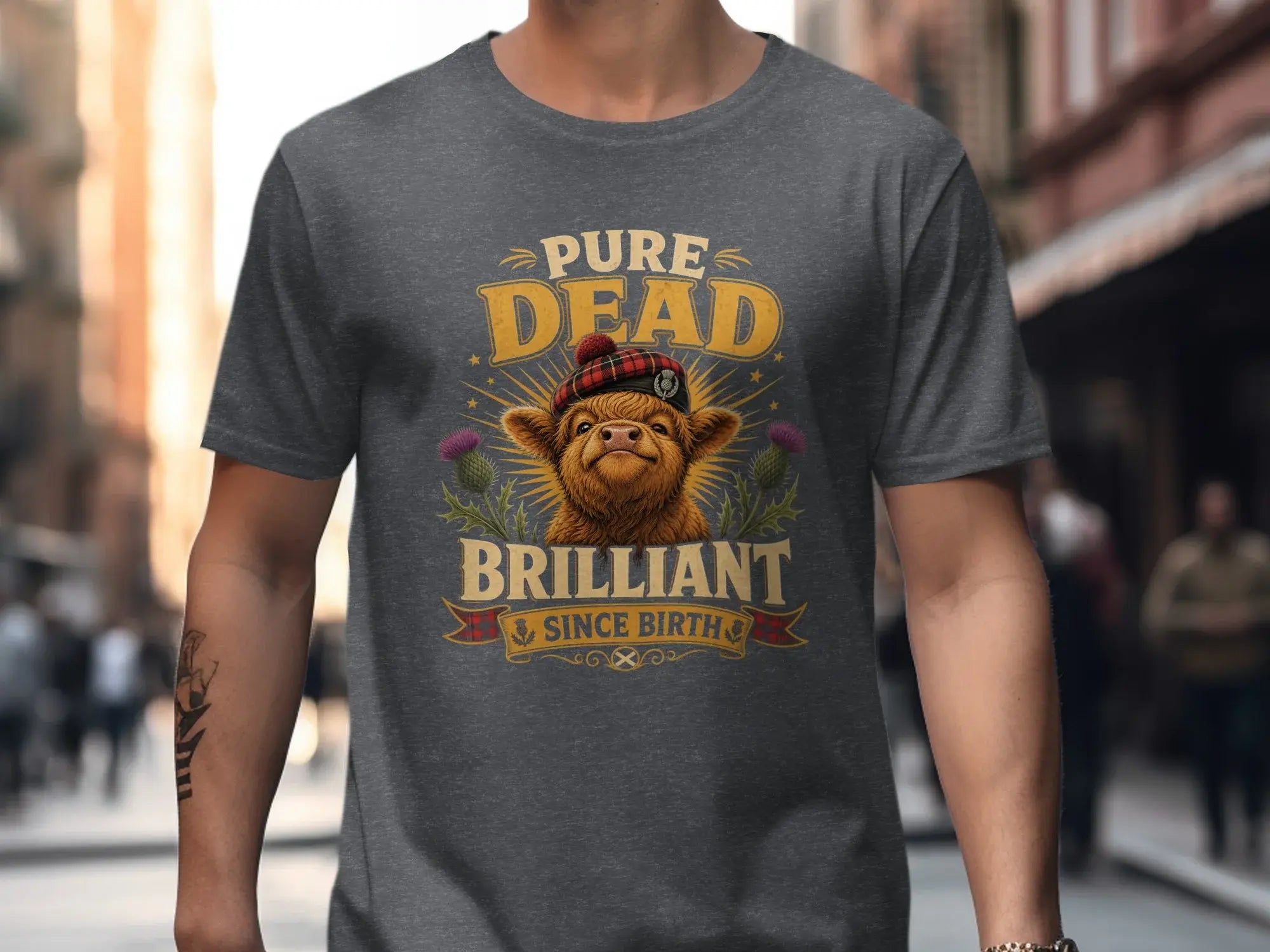 T-shirt with a Highland cow wearing a tartan hat, reading "Pure Dead Brilliant".