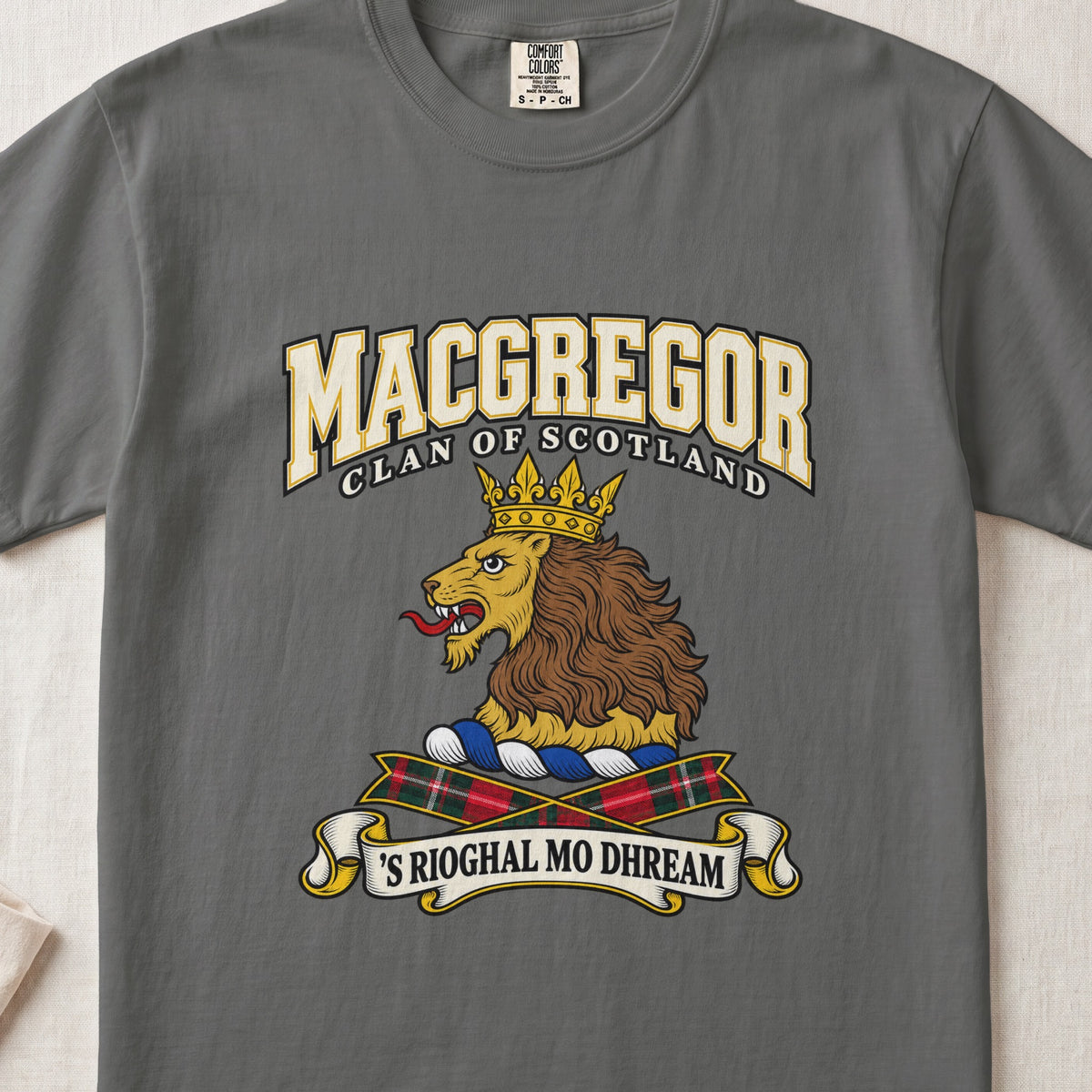 MacGregor graphic T-shirt in Pepper gray, front flat lay showing varsity lettering and gold lion head with brown mane and gold crown.