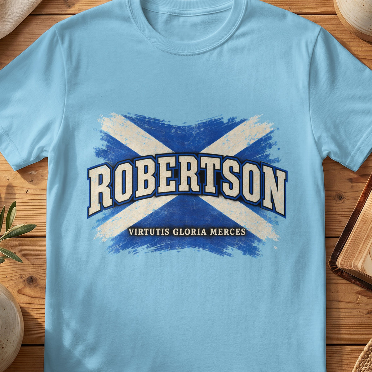 Robertson Scottish Saltire T-shirt in Sky, with distressed blue and cream flag and “Virtutis Gloria Merces” lettering.