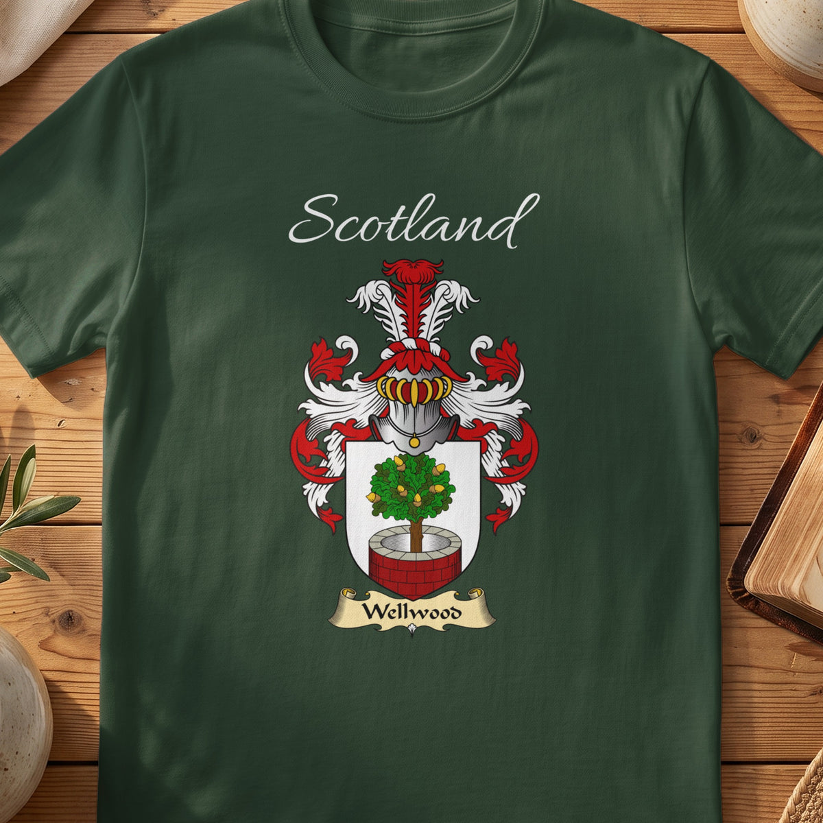 Forest Green Wellwood Scottish T-shirt laid flat with coat of arms artwork and “Scotland” text.