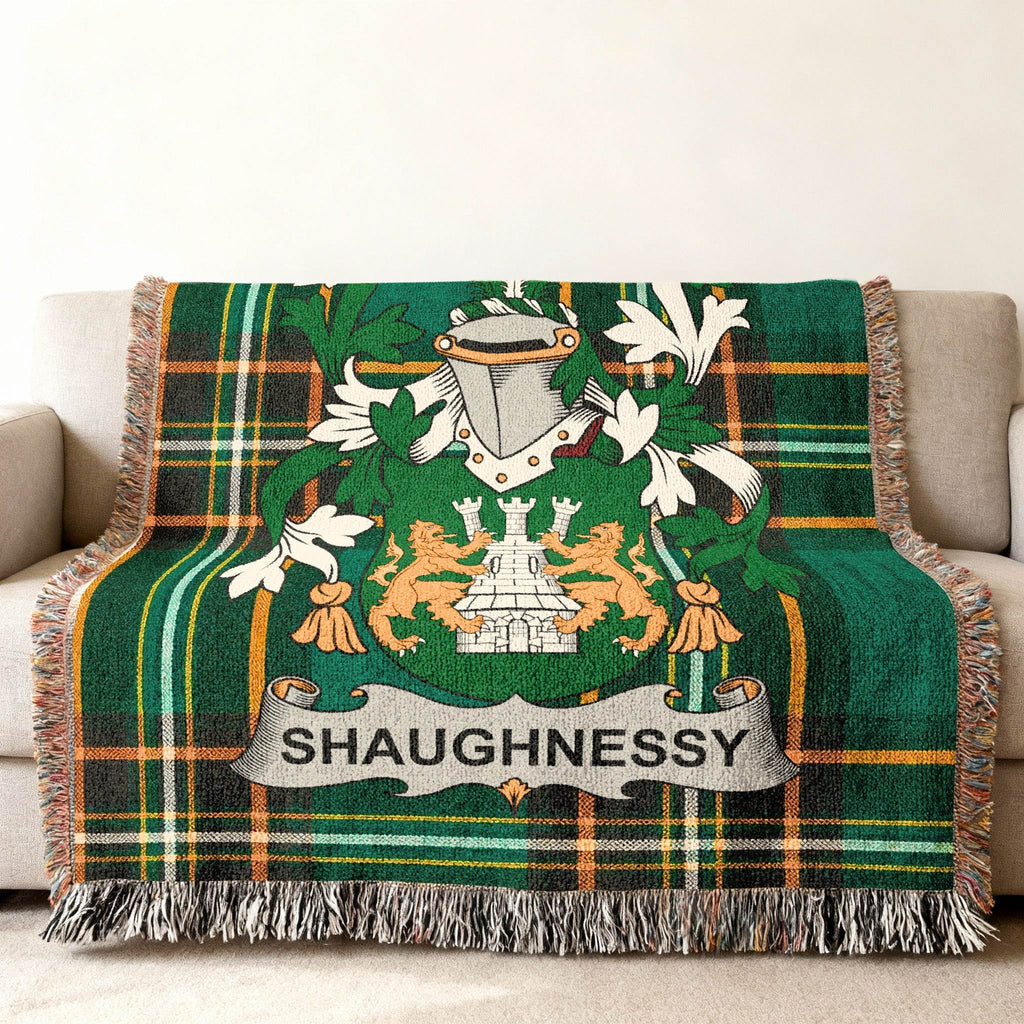 Shaughnessy tartan blanket with coat of arms draped over a couch.