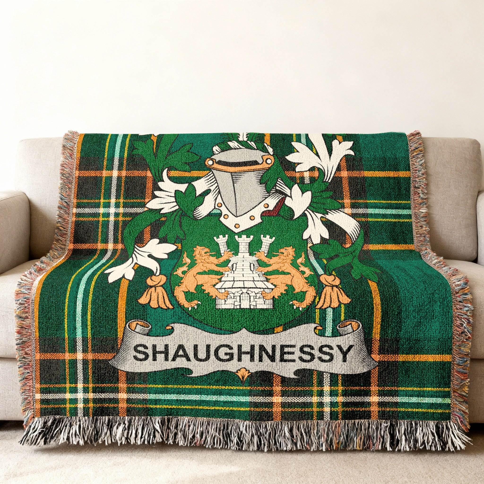 Shaughnessy tartan blanket with coat of arms draped over a couch.