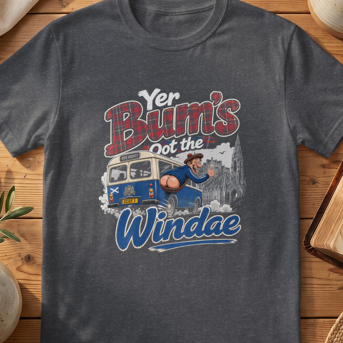 Dark grey Gildan 64000 unisex T-shirt flatlay with Yer Bum's Oot the Windae Scottish graphic design