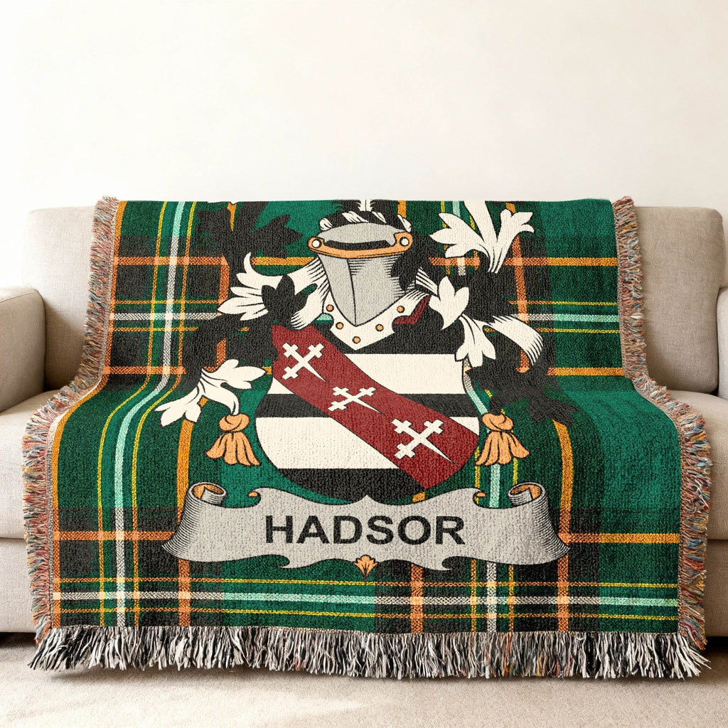Tartan blanket with the HADSOR family crest on a couch.