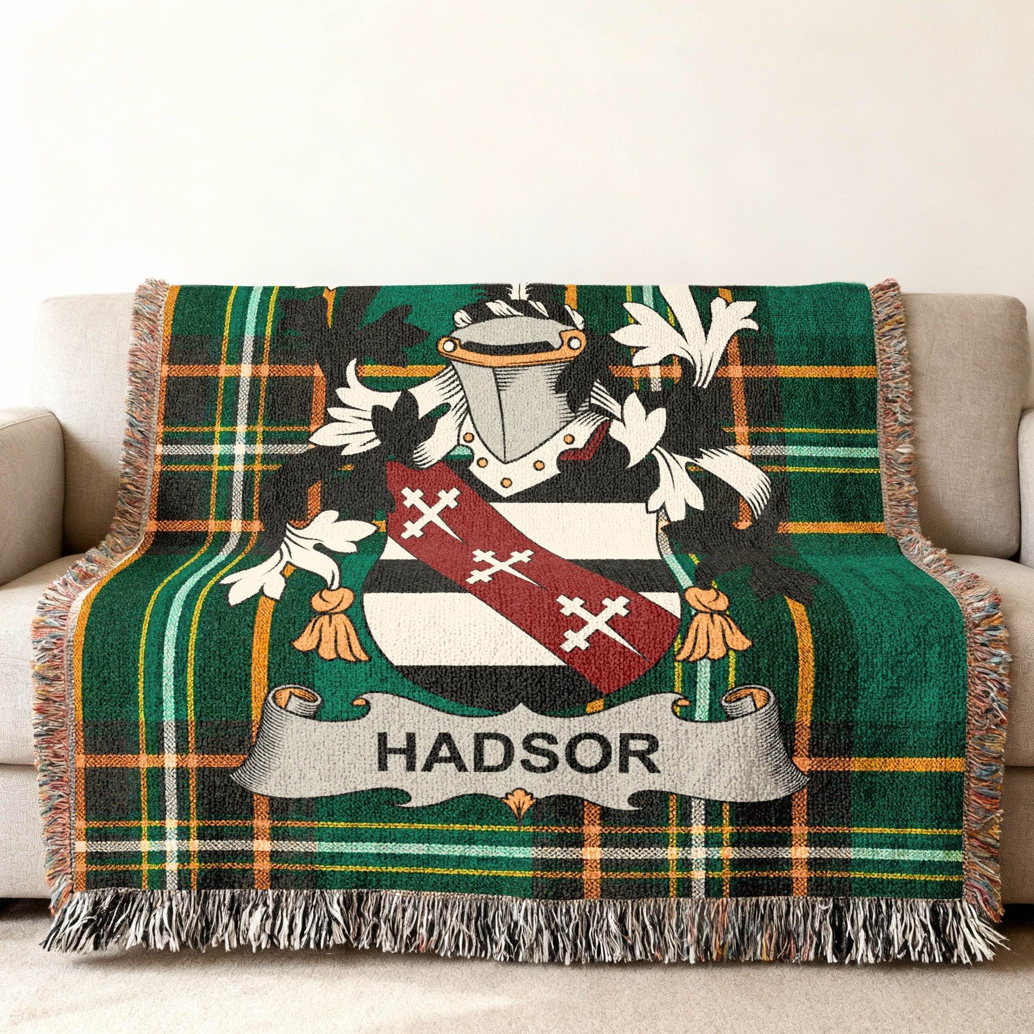 Tartan blanket with the HADSOR family crest on a couch.