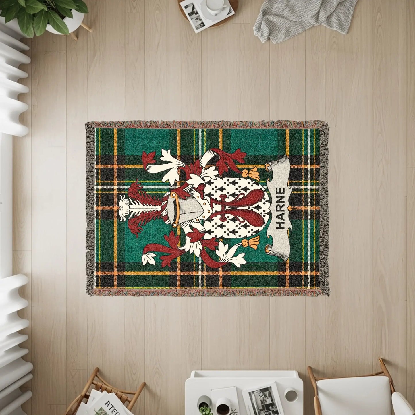 Woven blanket featuring the Harne family crest on a green and red plaid background.