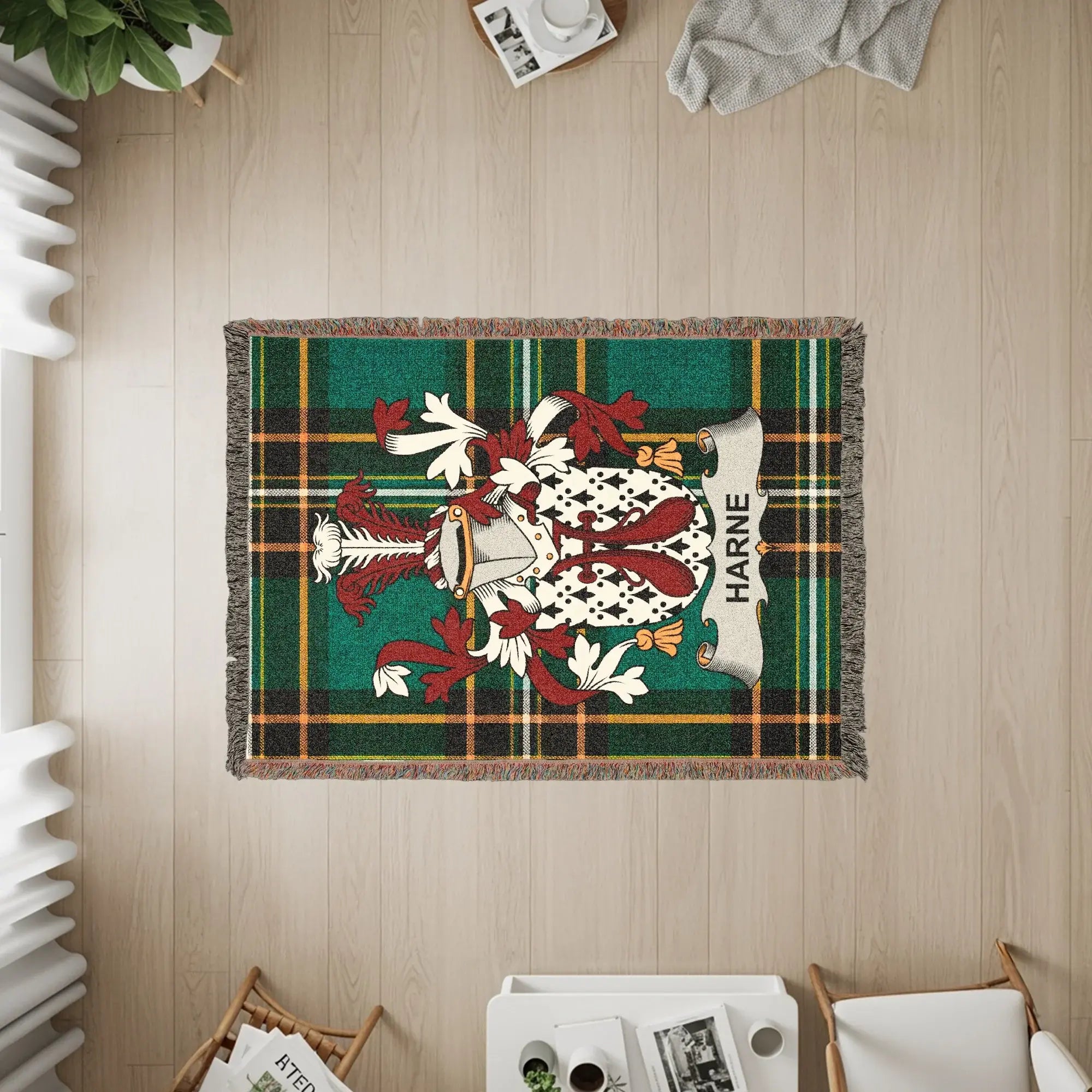 Woven blanket featuring the Harne family crest on a green and red plaid background.