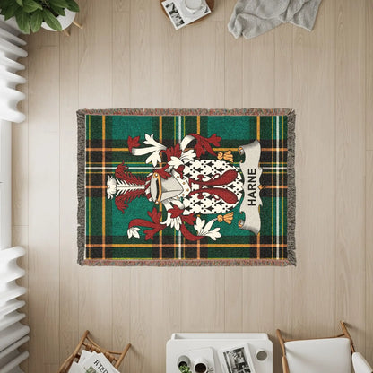 Woven blanket featuring the Harne family crest on a green and red plaid background.