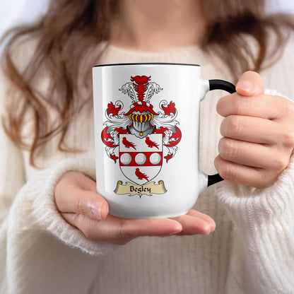 White mug with black rim, featuring the Besley family crest.