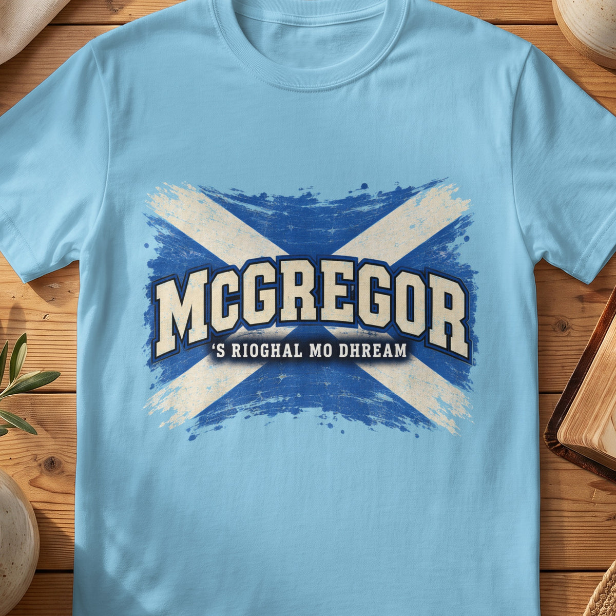 McGregor Scottish Saltire T-shirt in Sky, with distressed blue and cream flag and “'S Rioghal Mo Dhream” lettering.