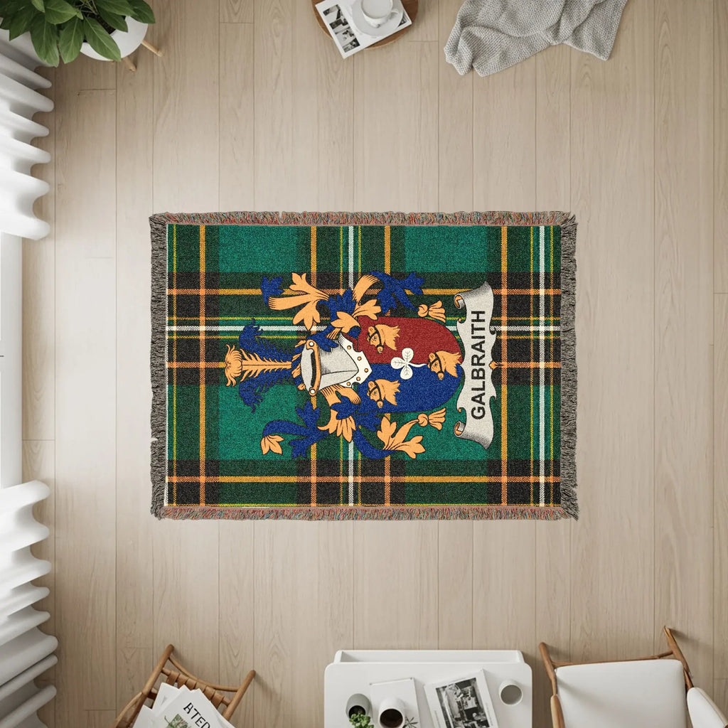 Galbraith tartan blanket with a coat of arms and fringe, displayed on a wooden floor.
