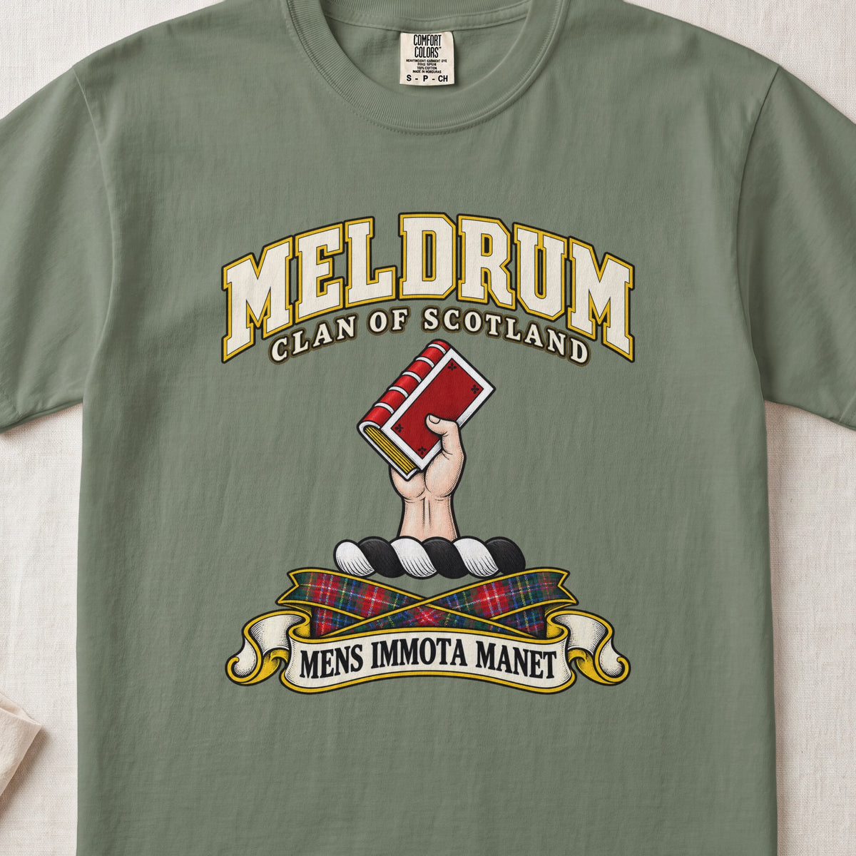 Meldrum Scottish clan T-shirt in Moss, front view with a hand holding a red book and motto banner.