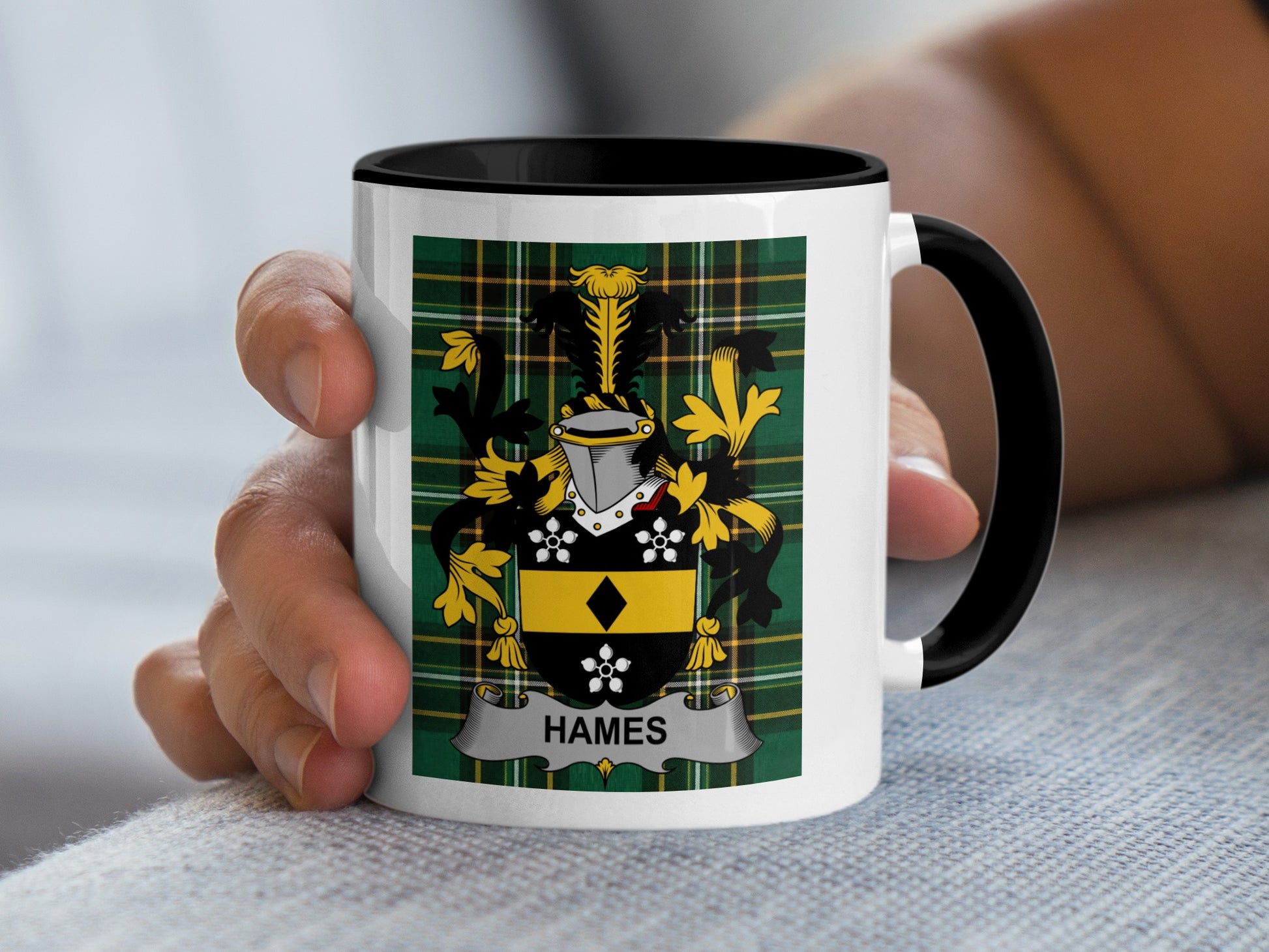 White mug with black handle displaying a tartan pattern and the crest "HAMES".