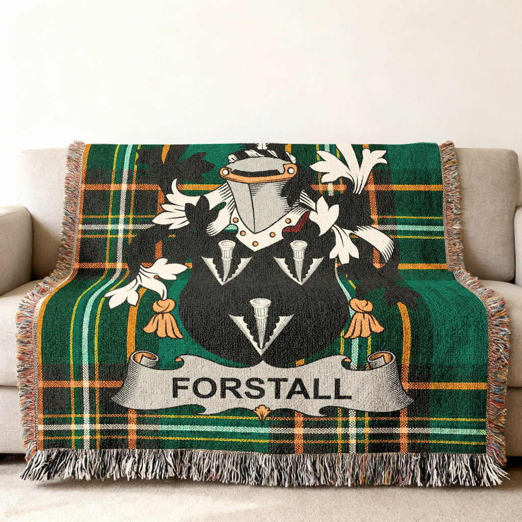 Forstall family crest woven throw blanket on a sofa.