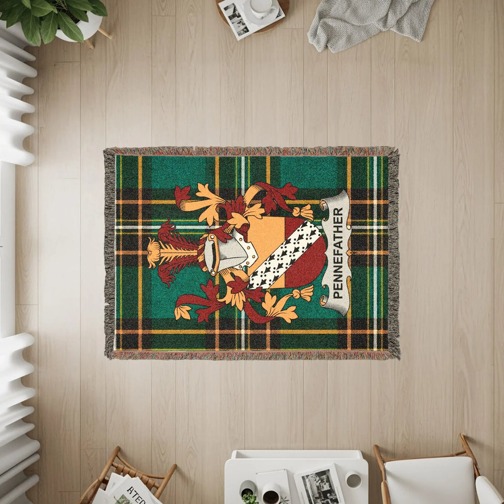 Woven blanket with Pennefather family crest on tartan background.