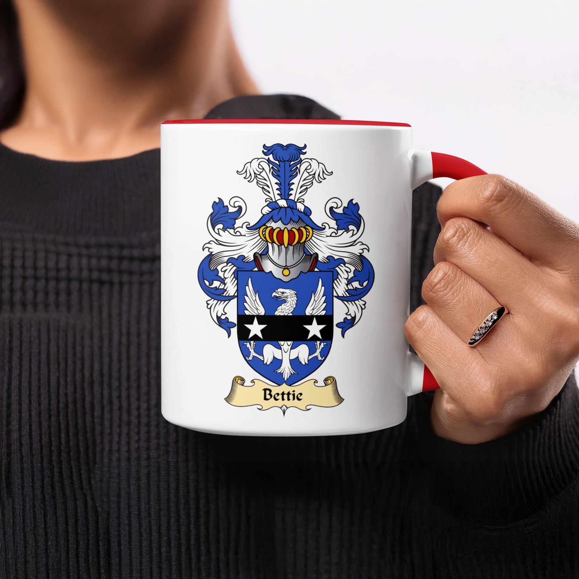 White mug with red rim and handle, featuring a coat of arms and "Bettie".