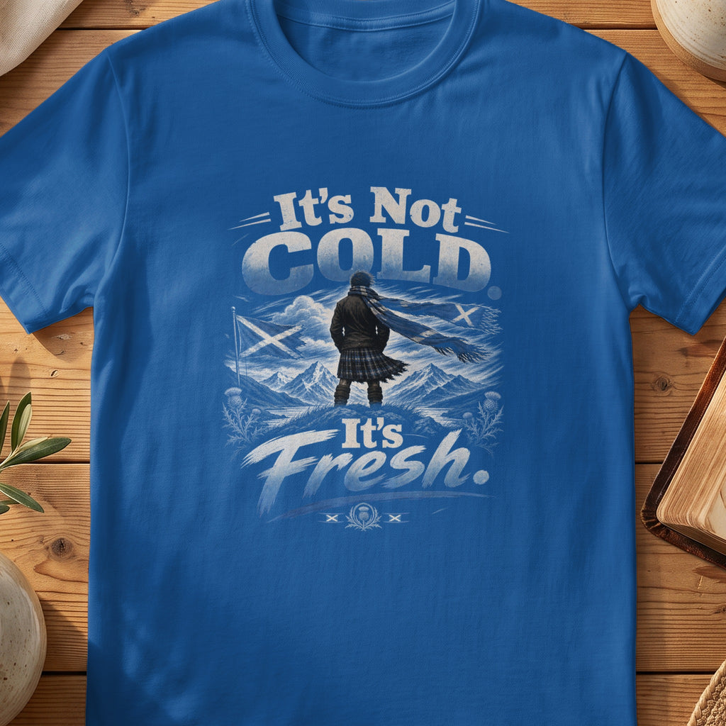 Blue t-shirt with graphic of man in kilt, scarf, and mountains, text "It's Not COLD It's Fresh."