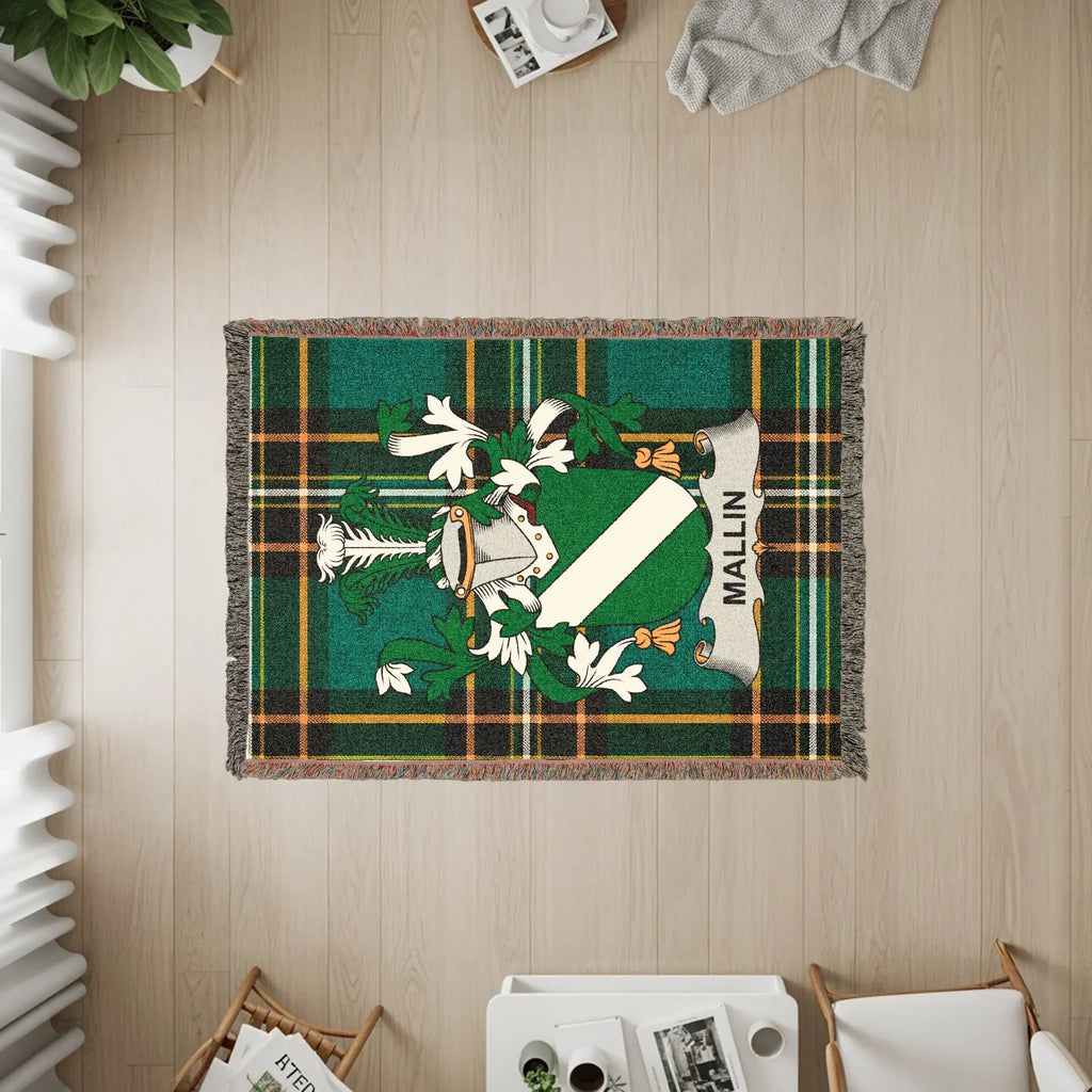 Green plaid woven blanket with the Mallin family crest centered.