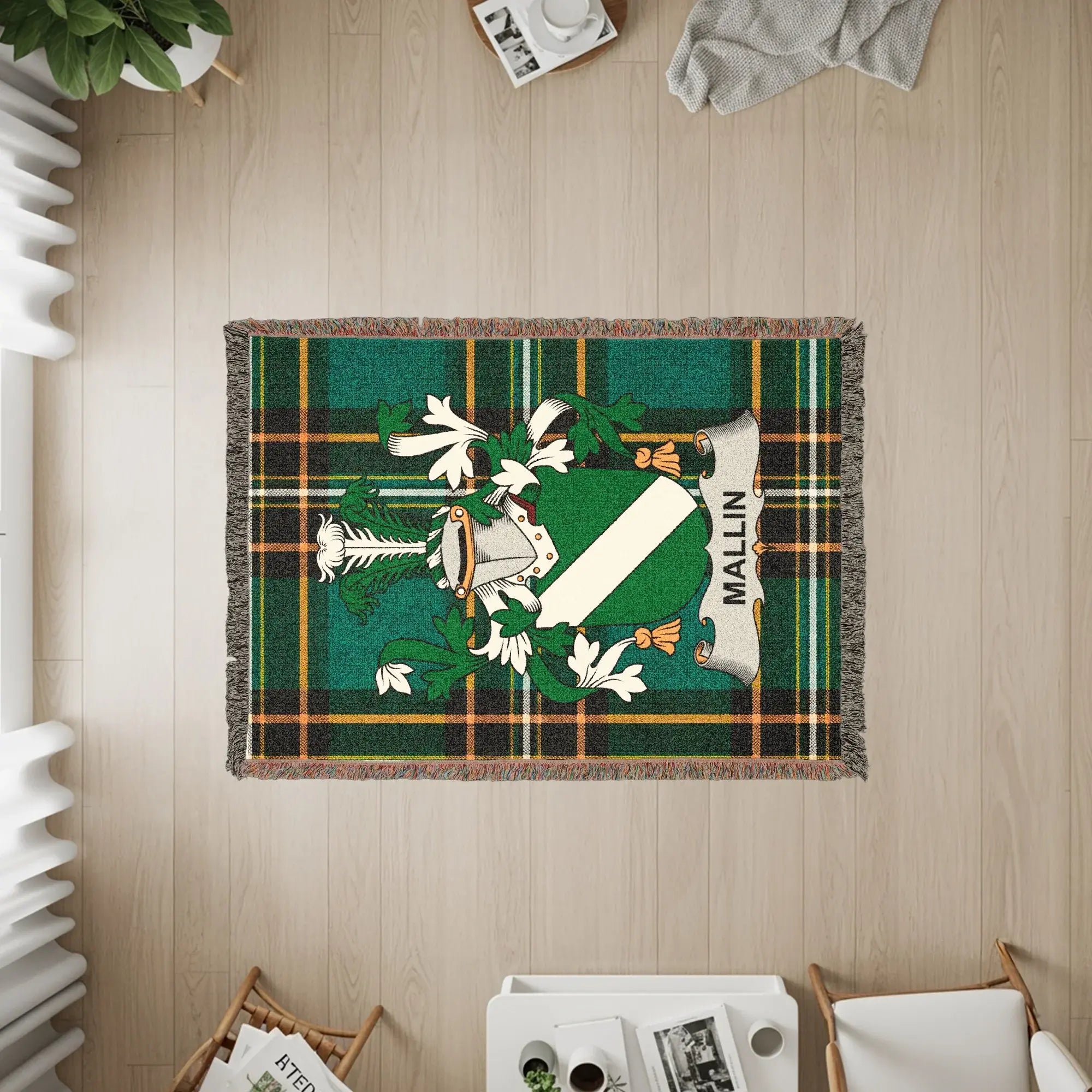Green plaid woven blanket with the Mallin family crest centered.