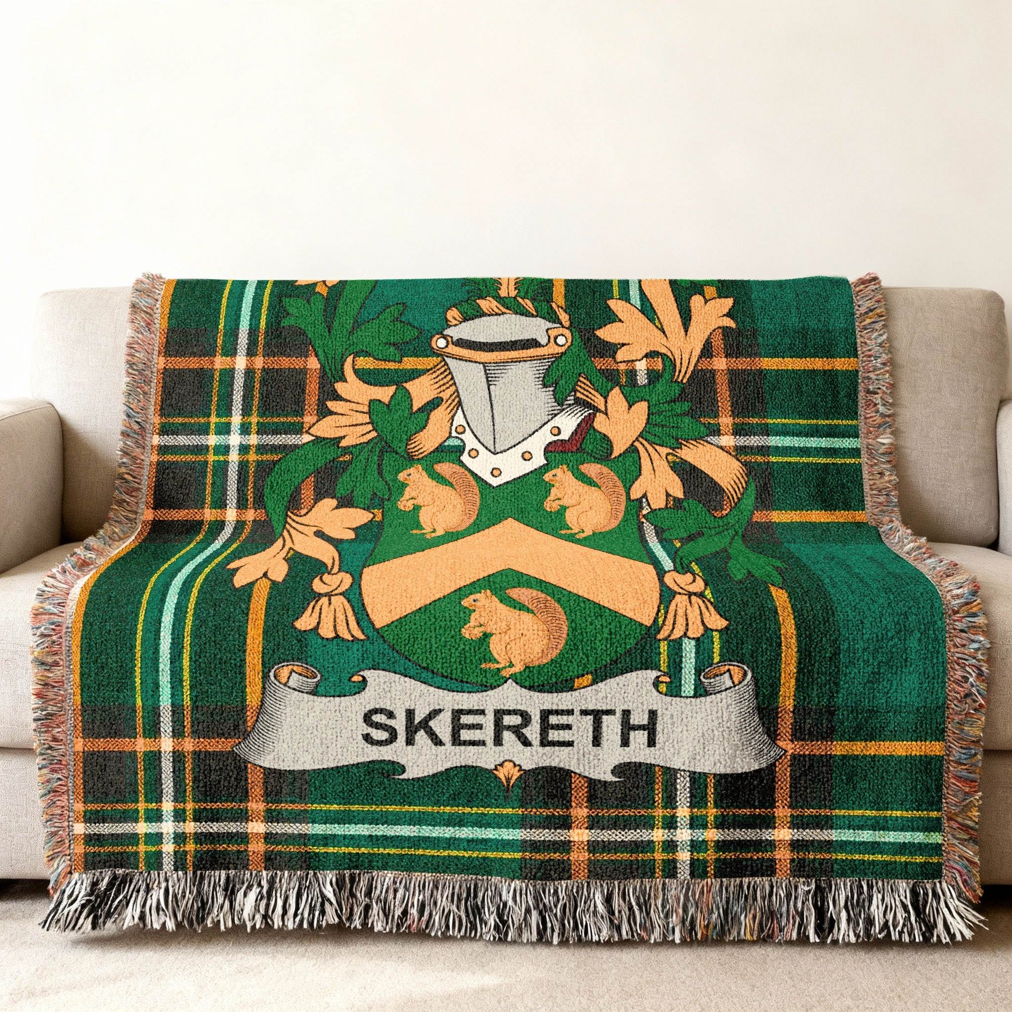 Green tartan blanket with a family crest featuring squirrels and the name "SKERETH".