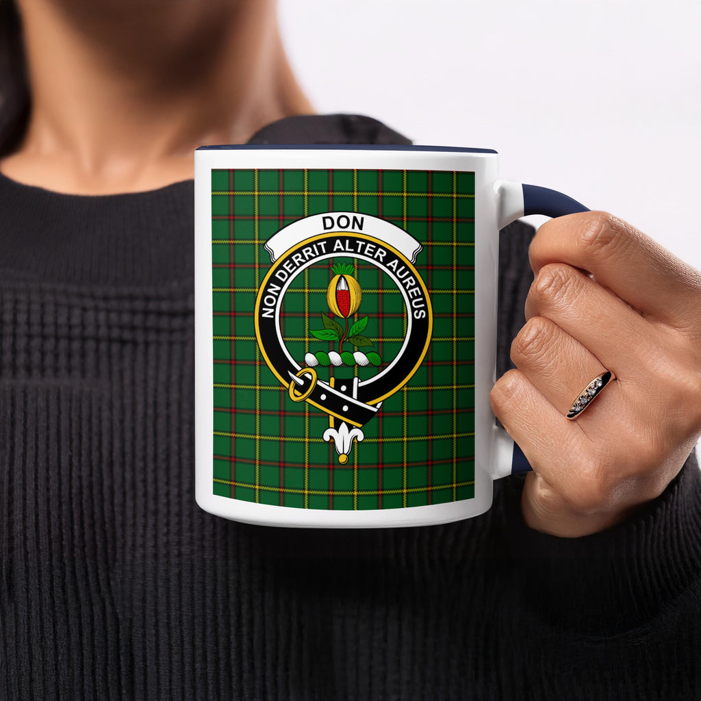 Close-up lifestyle view of Don Scottish surname crest artwork on a navy 11 oz accent mug with a tartan background