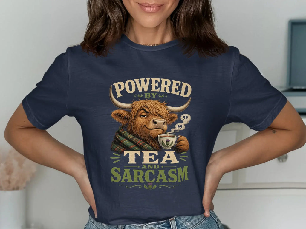 T-shirt with a Highland cow drinking tea and text "Powered by tea and sarcasm".