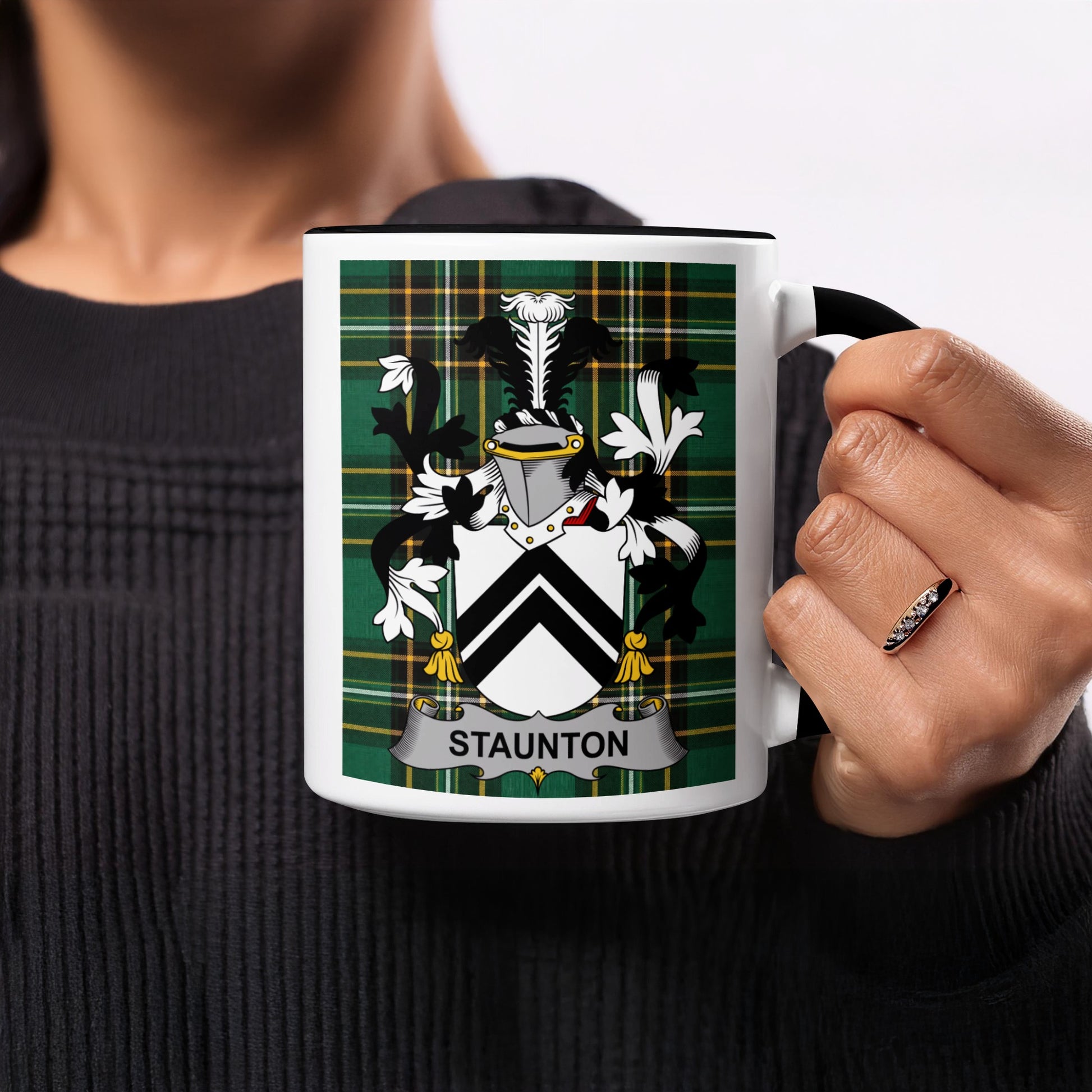 Mug with Staunton family crest on a green plaid background.