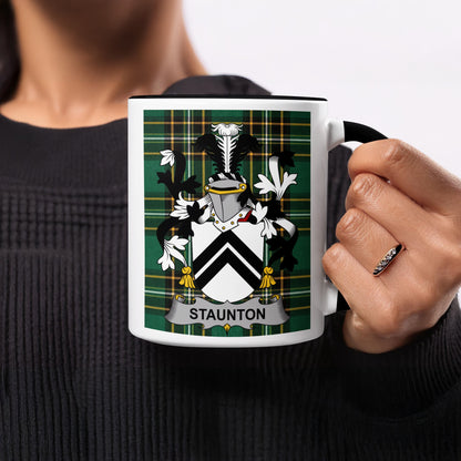 Mug with Staunton family crest on a green plaid background.