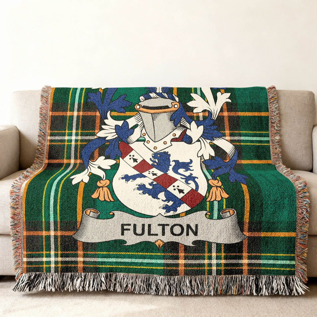 Green plaid blanket with the Fulton family crest in the center.