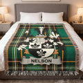Green plaid blanket with a coat of arms featuring the name NELSON.