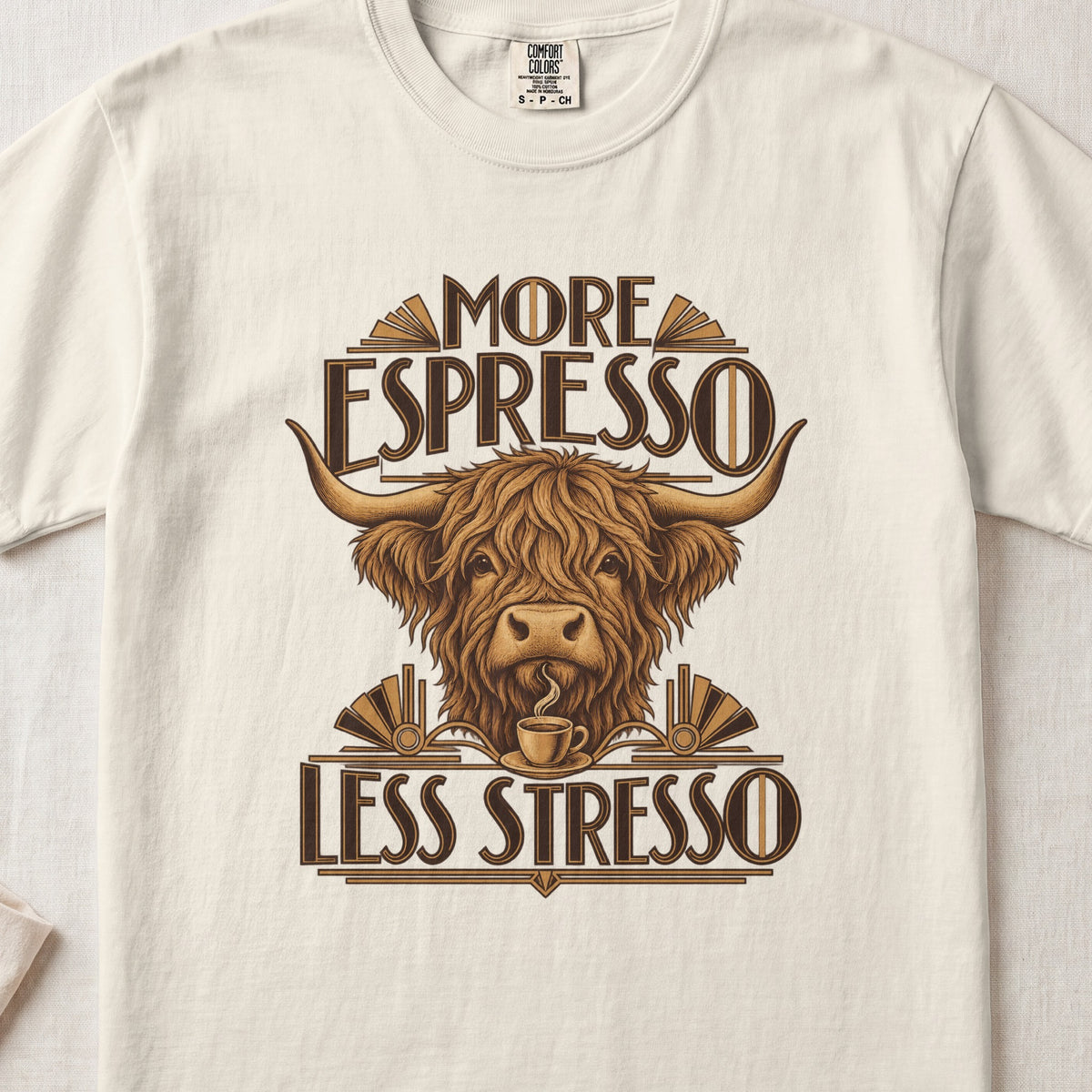 More Espresso, Less Stresso Highland cow design on an Ivory Comfort Colors 1717 T-shirt, flat lay