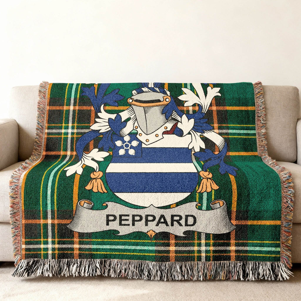 Woven throw blanket with Peppard family crest on green plaid.
