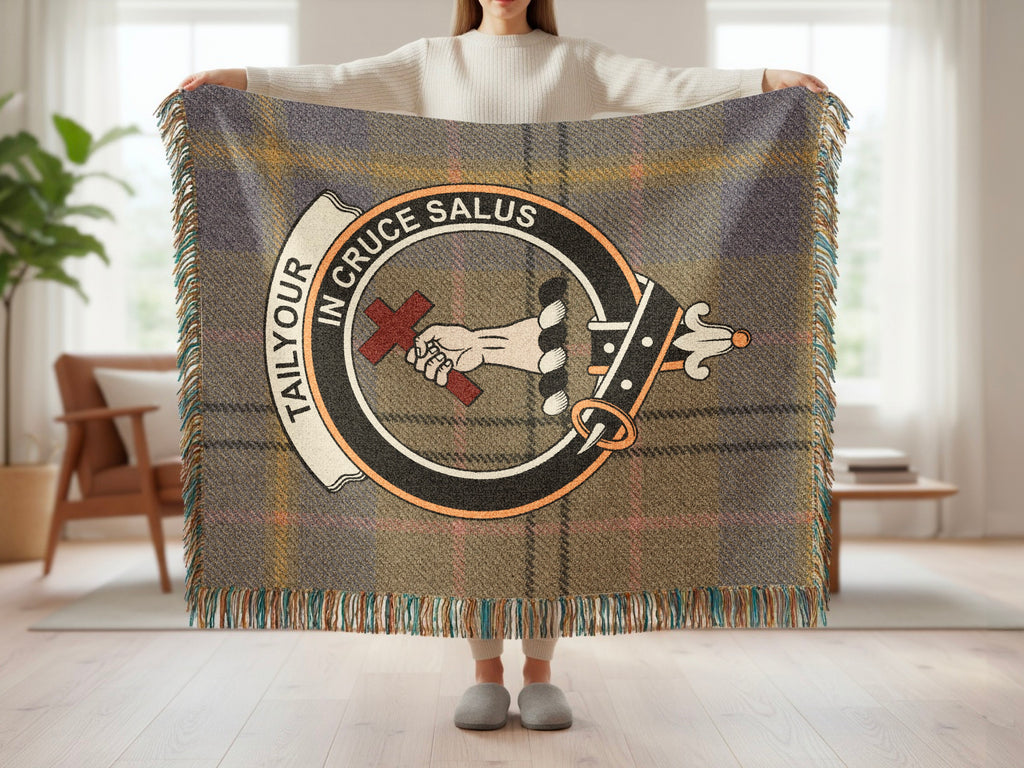 Person holding the Tailyour woven blanket to show the full design, tartan background and fringe