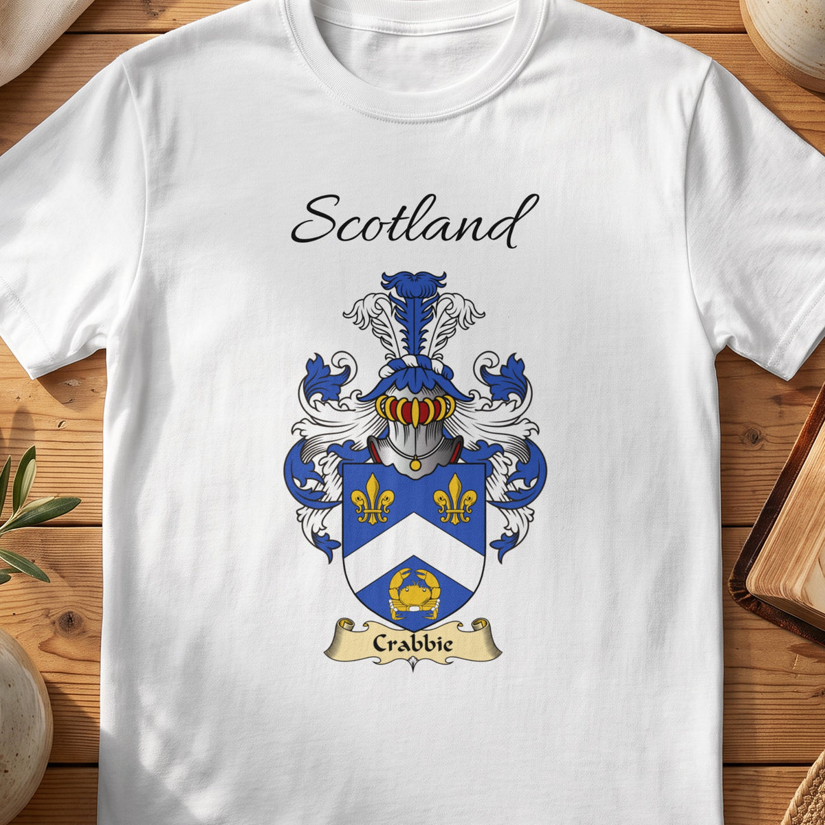 White Crabbie Scottish family shield T-shirt featuring a white chevron and gold motifs on blue